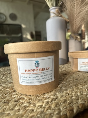 This image is of a brown paper tub with A bone broth based soup for dogs with pumpkin and healing spices.